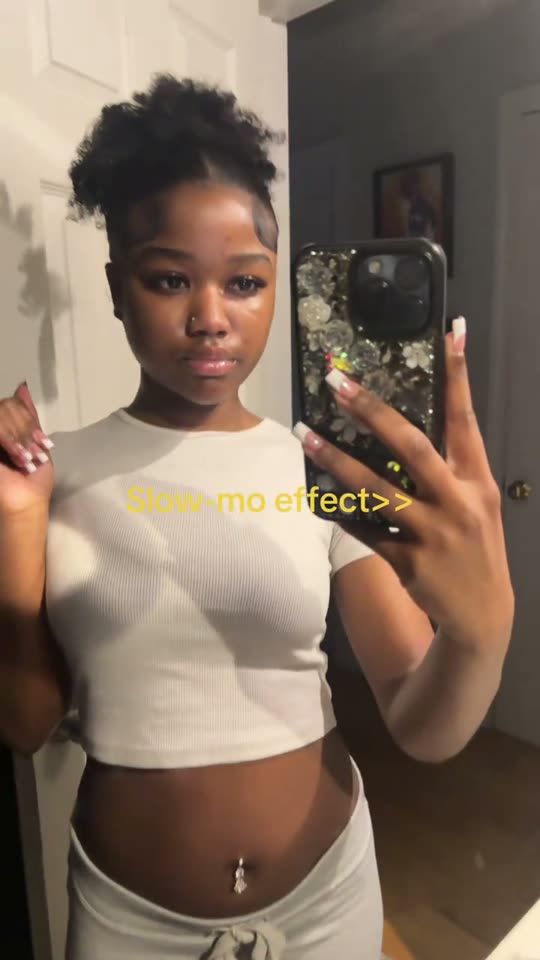 Woman filming herself in mirror