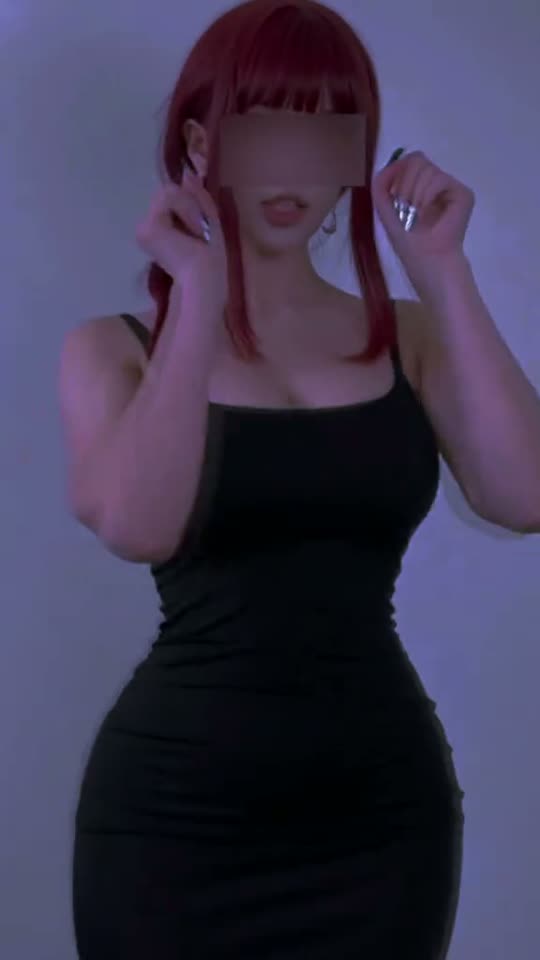 Woman in black dress posing