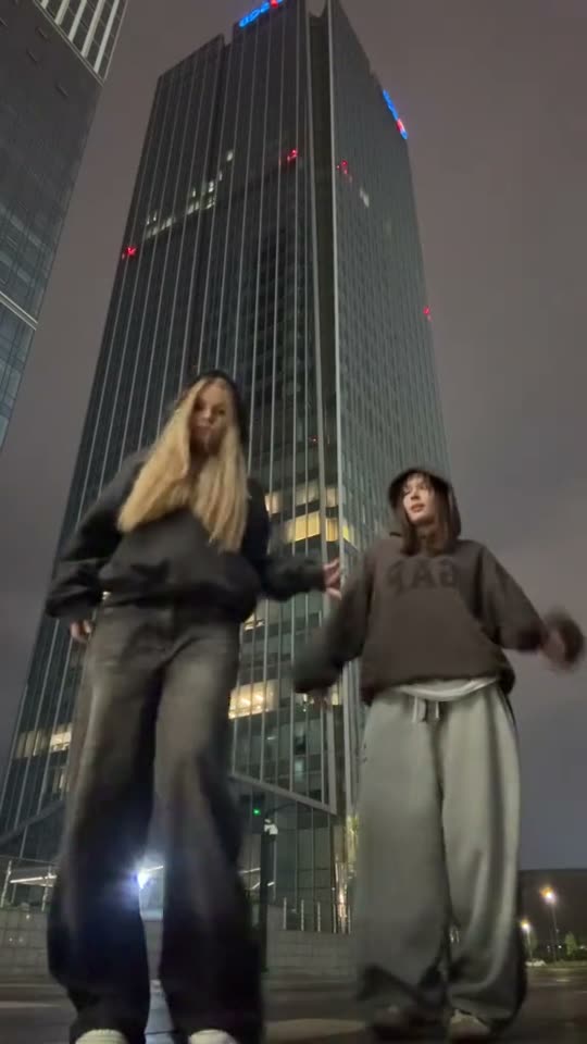 Two girls dancing at night