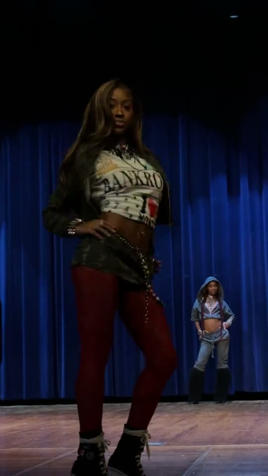 Woman poses on stage
