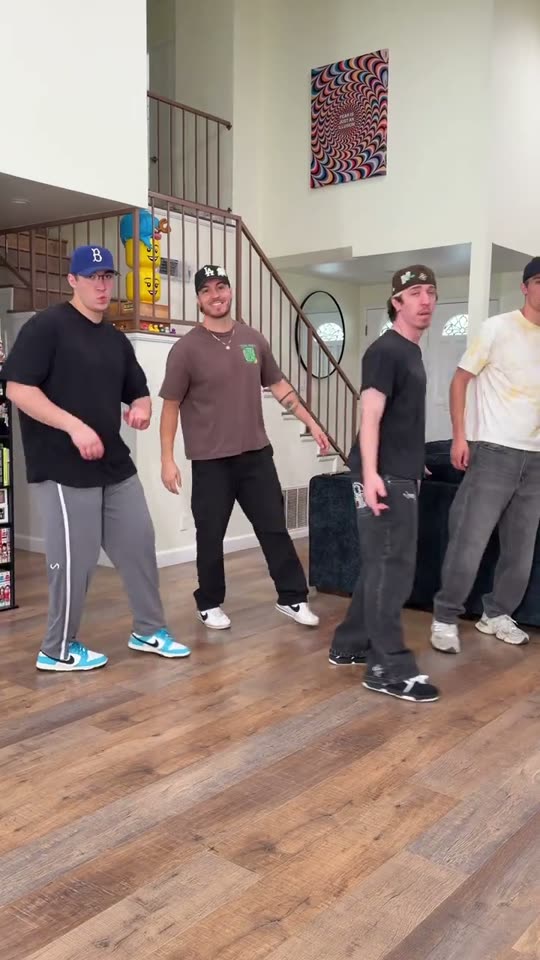 Four men dancing together