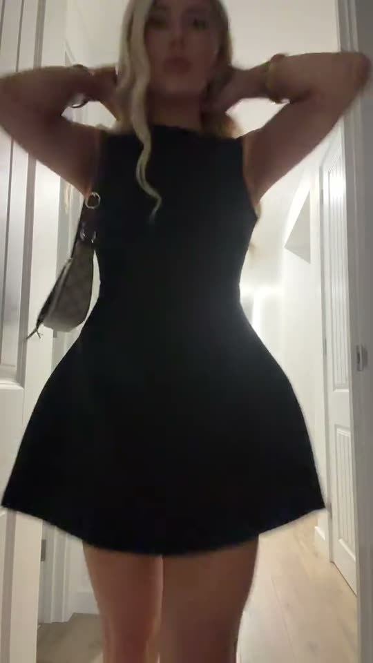 Woman in black dress poses