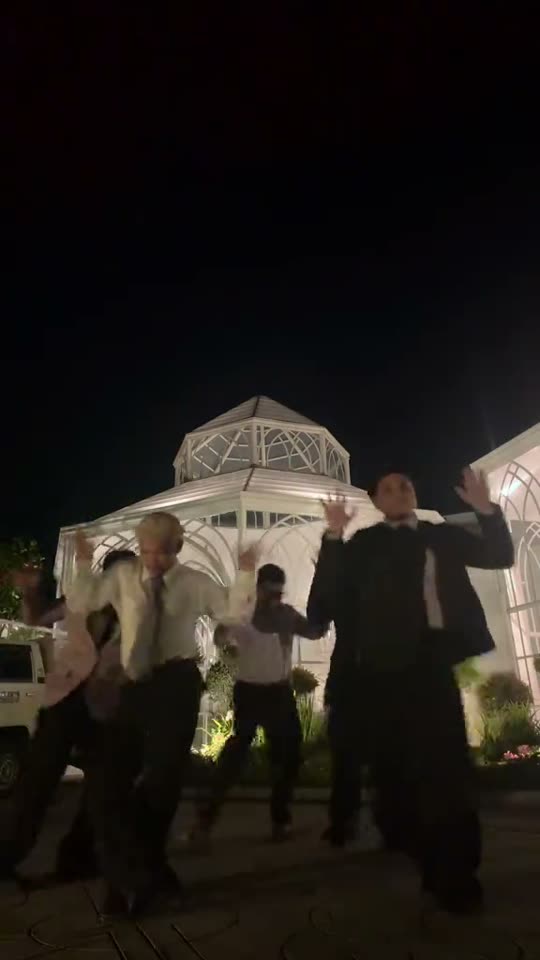 Group of men dancing outdoors