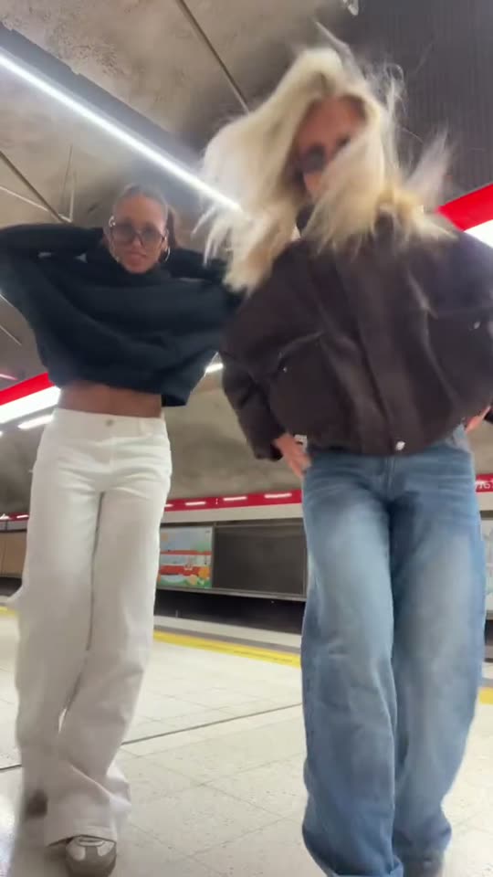 Two girls dancing at subway