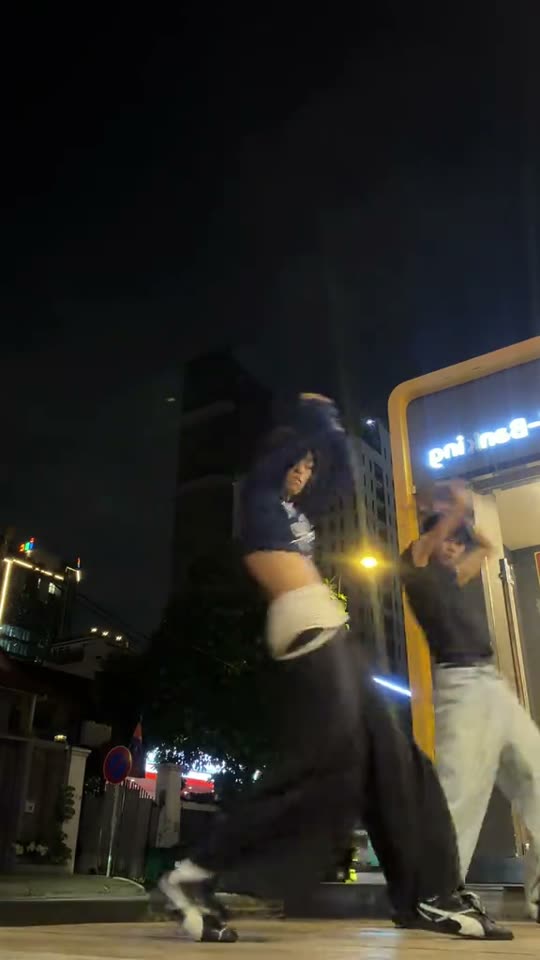 Two people dancing at night
