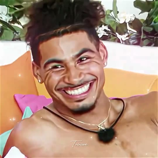 Man smiling with hair bun