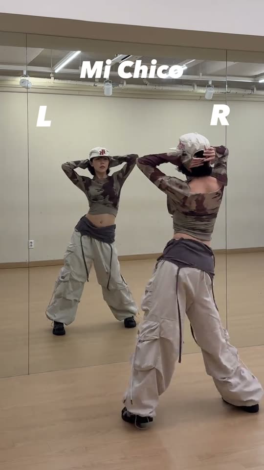 Woman dances in front of mirror