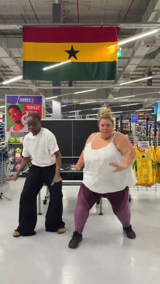 Two people dancing in store