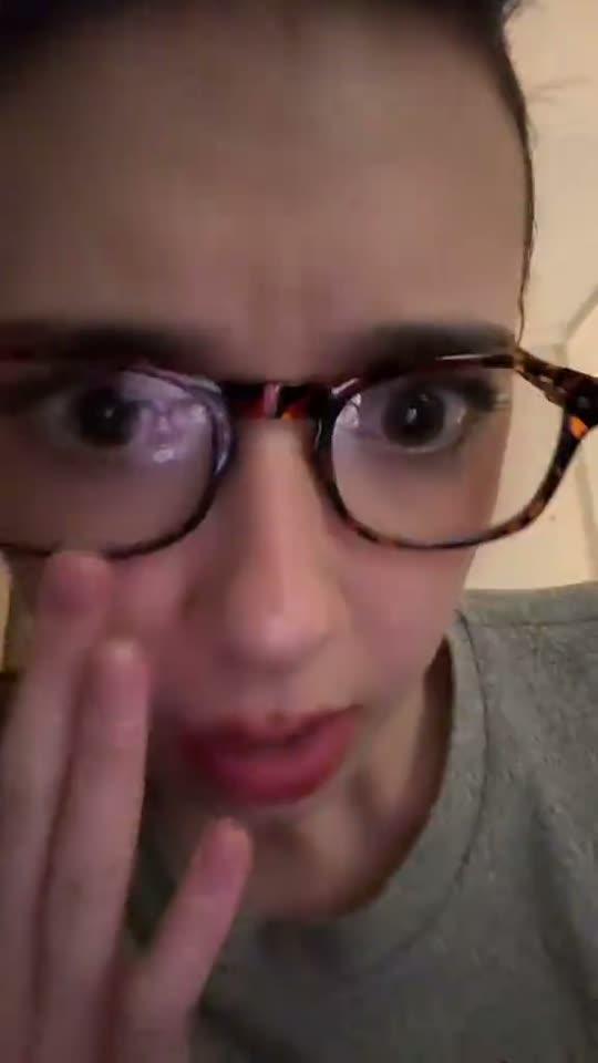 Woman with glasses looking surprised