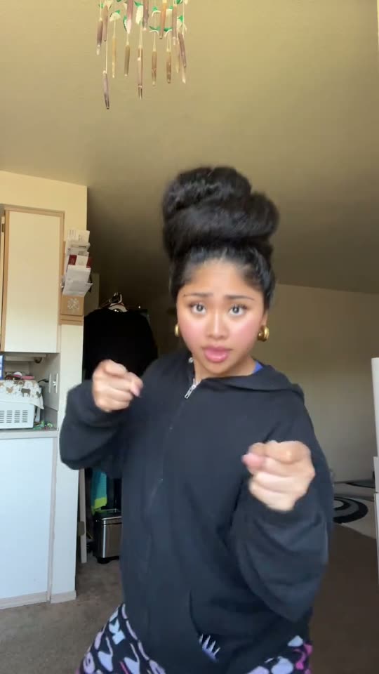Woman dances in black hoodie