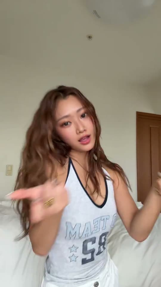 Woman dances in bedroom