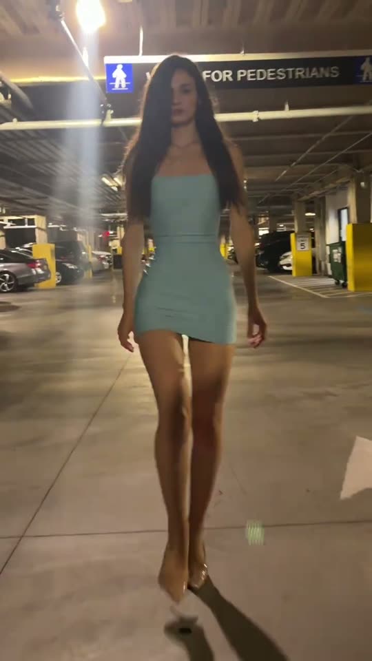Woman walks in parking garage