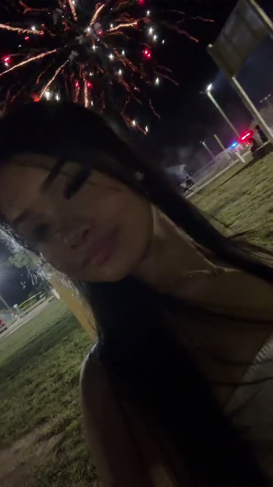 Woman enjoying fireworks at night