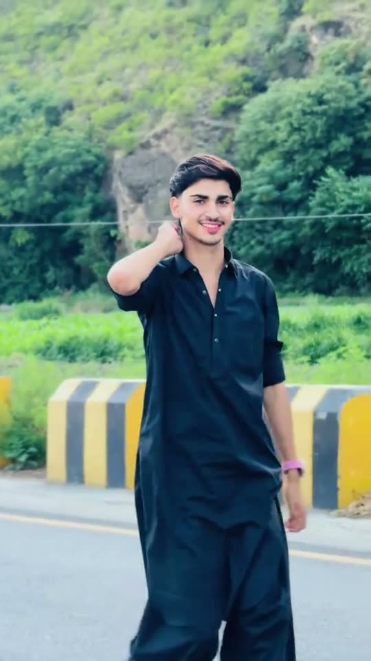 Man posing by roadside