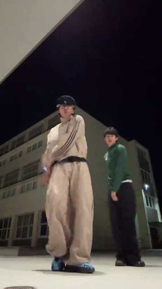 Two people dancing at night