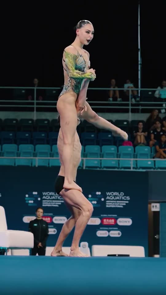 Synchronized swimmers perform a lift