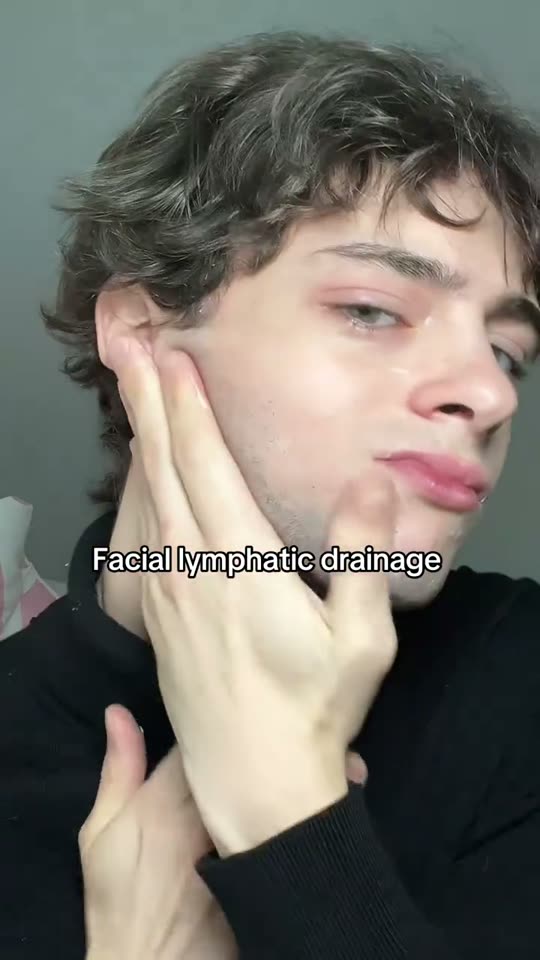 Man performs facial lymphatic drainage