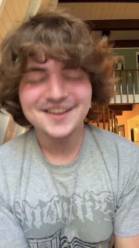 Smiling man with curly hair