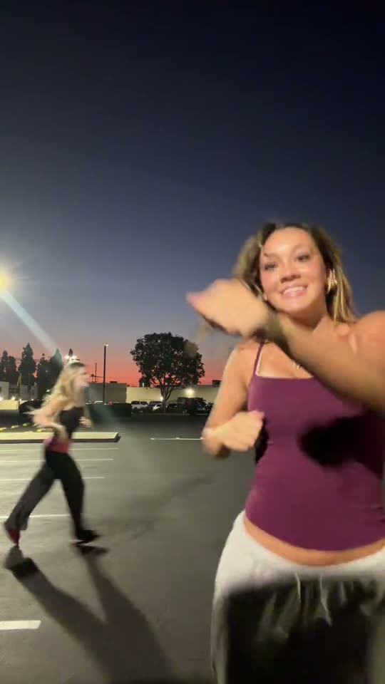 Two women dancing outdoors