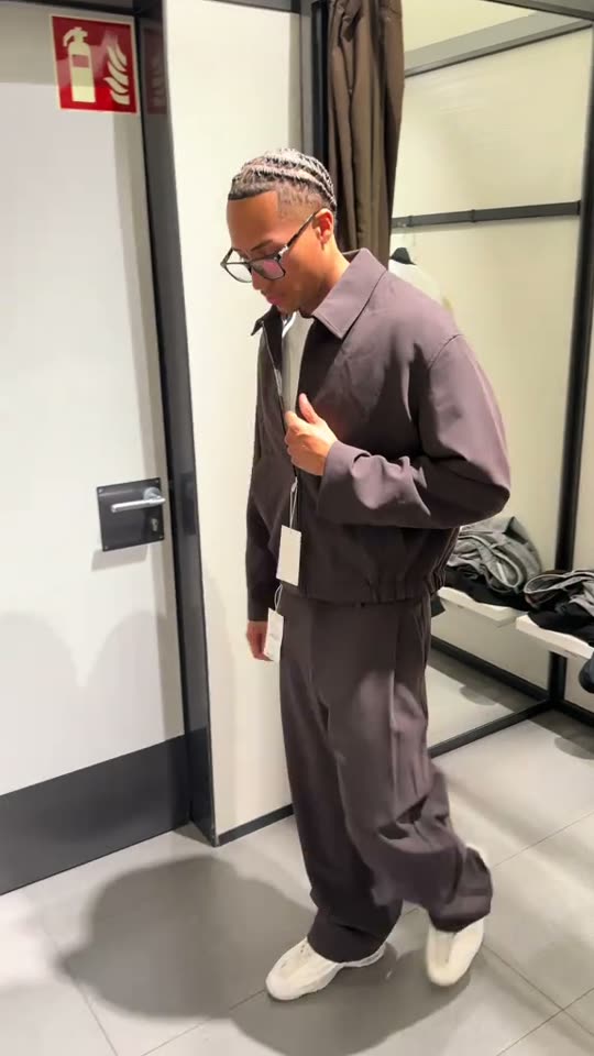 Man tries on brown outfit