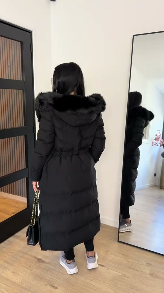 Woman models a black coat