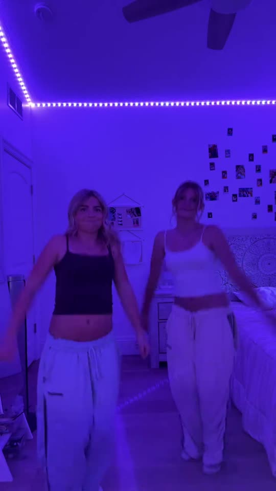 Two girls dancing in bedroom