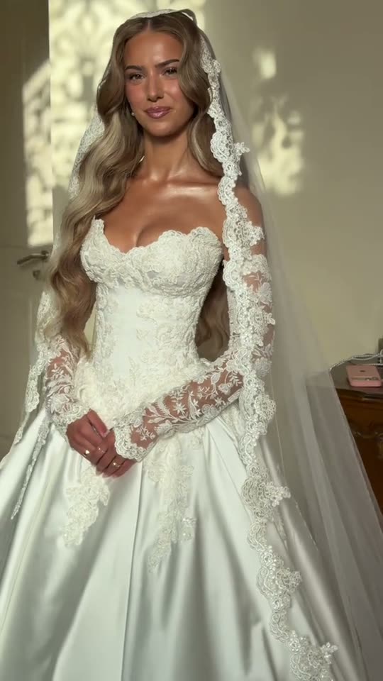 Woman poses in wedding dress