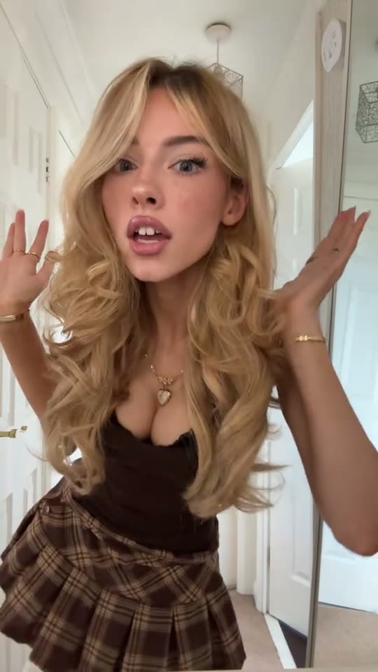 Blonde woman poses in outfit