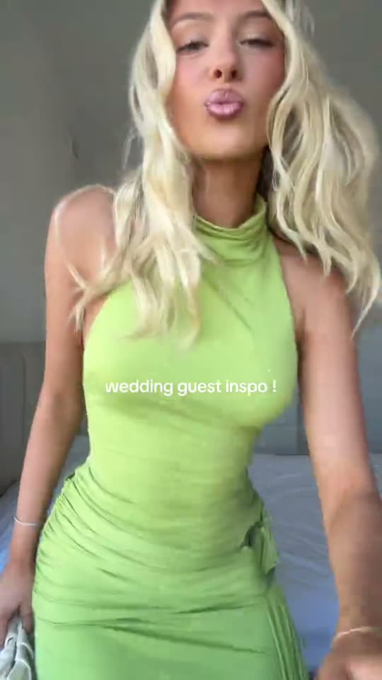 Woman poses in green dress