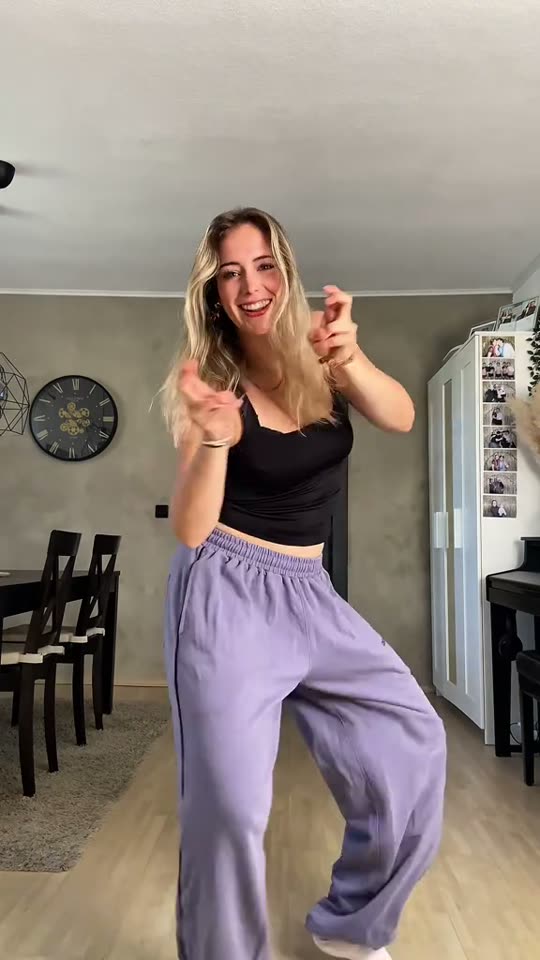 Woman dances in living room