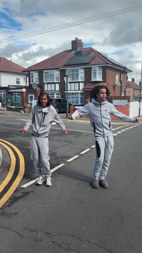 Two men dancing on street