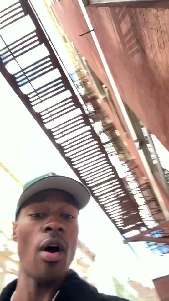 Man looking up at fire escape