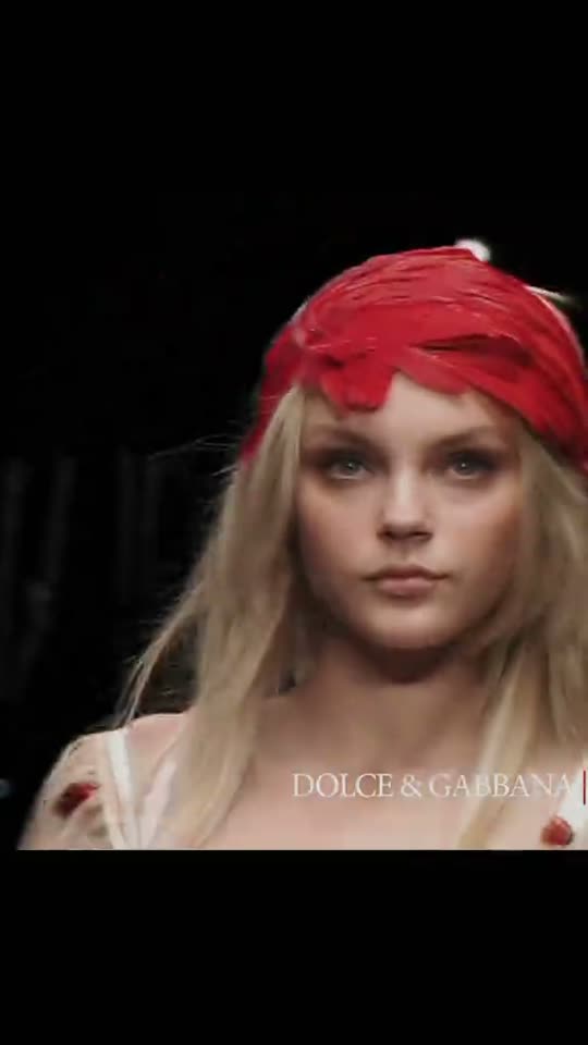 Model walking in red headpiece