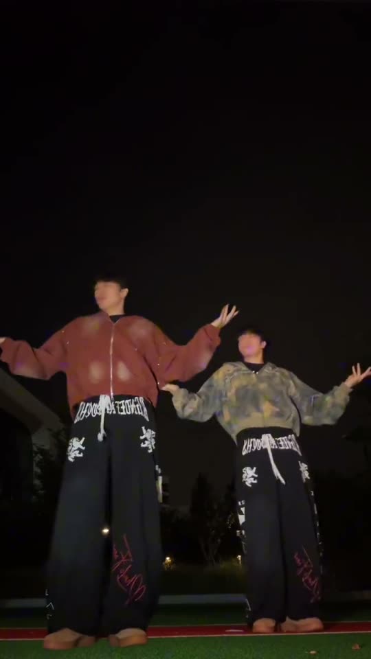 Two people dancing outdoors