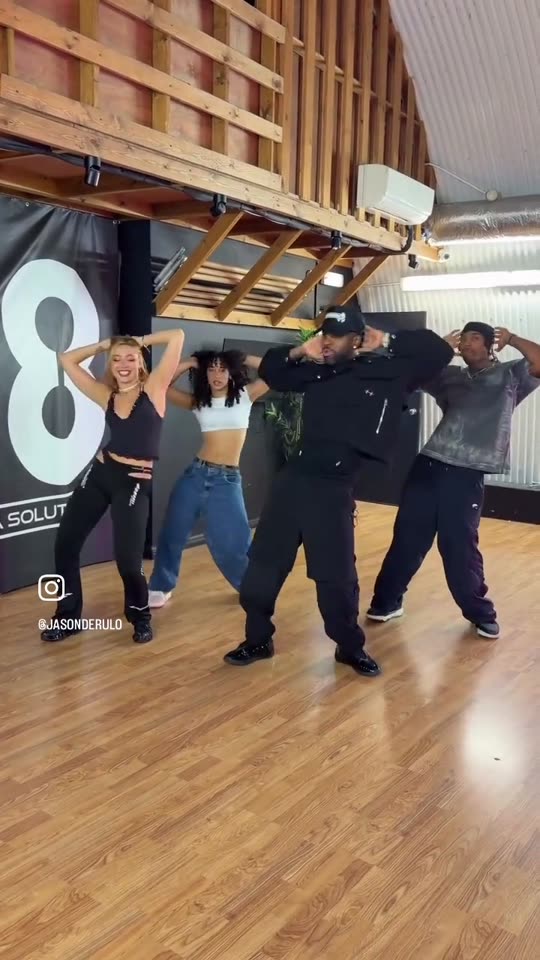 Four people dancing in studio