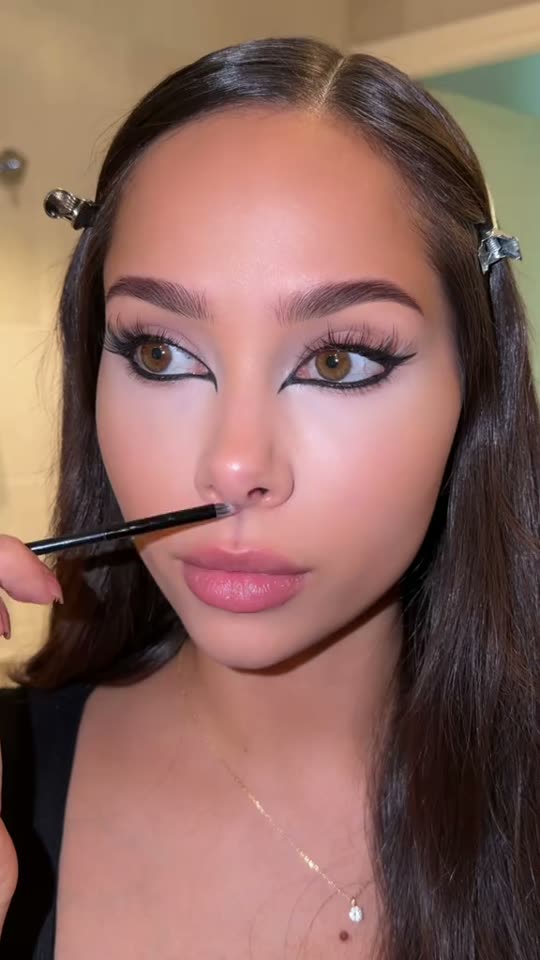 Applying dramatic eye makeup