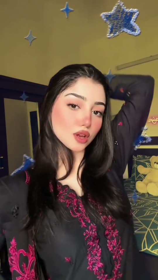 Woman poses in black dress