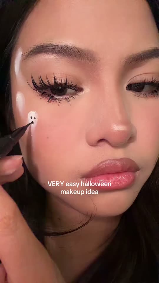 Applying ghost Halloween makeup