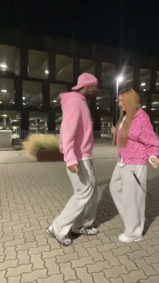 Two people dancing outdoors