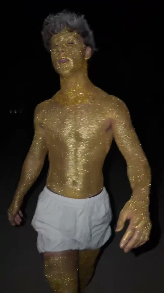 Man covered in gold glitter