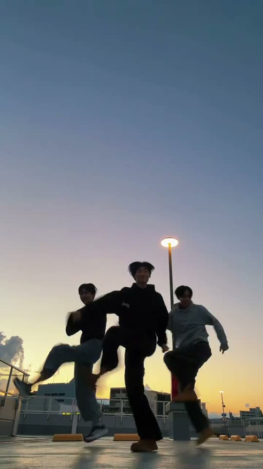 Three friends dancing at sunset