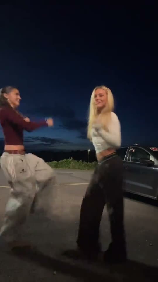 Two girls dancing outdoors