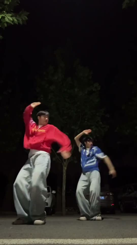 Two people dancing at night