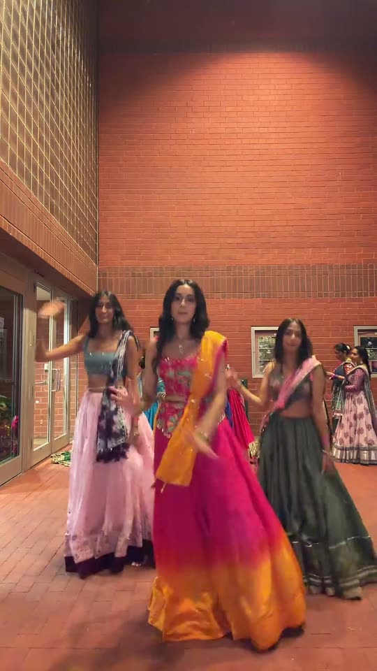 Three women doing Garba dance