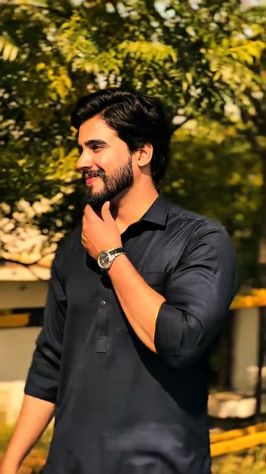 Man poses in black shirt