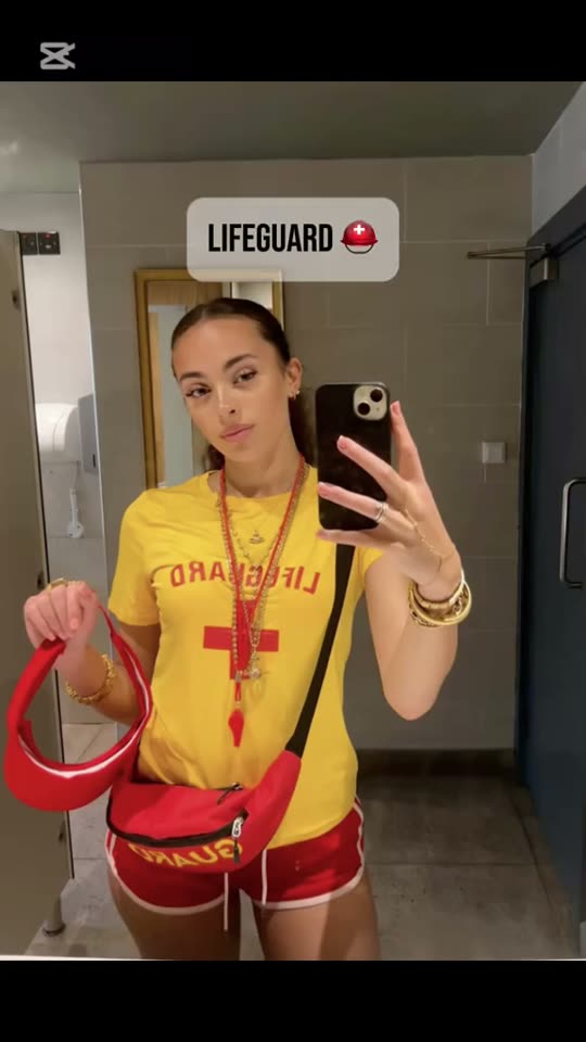 Woman poses in lifeguard costume
