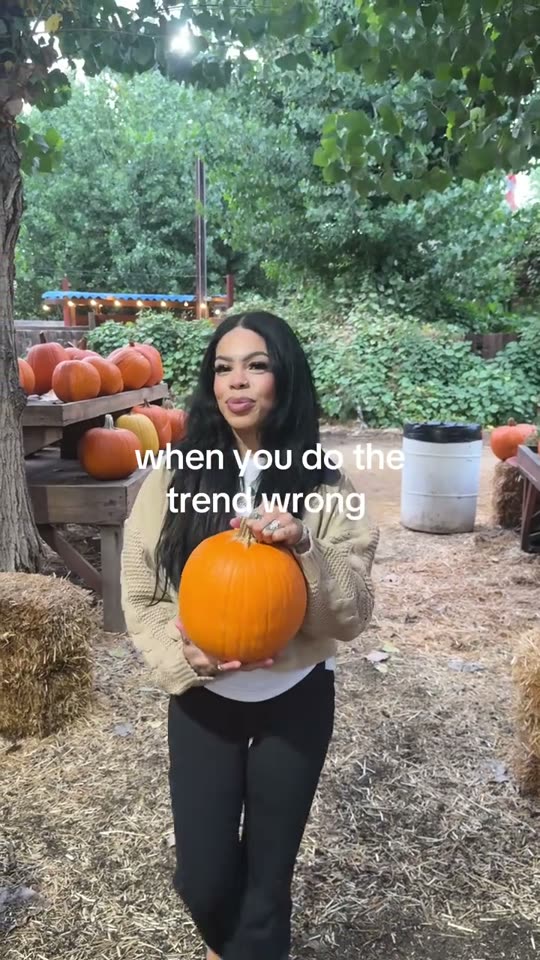 Woman holds pumpkin for trend