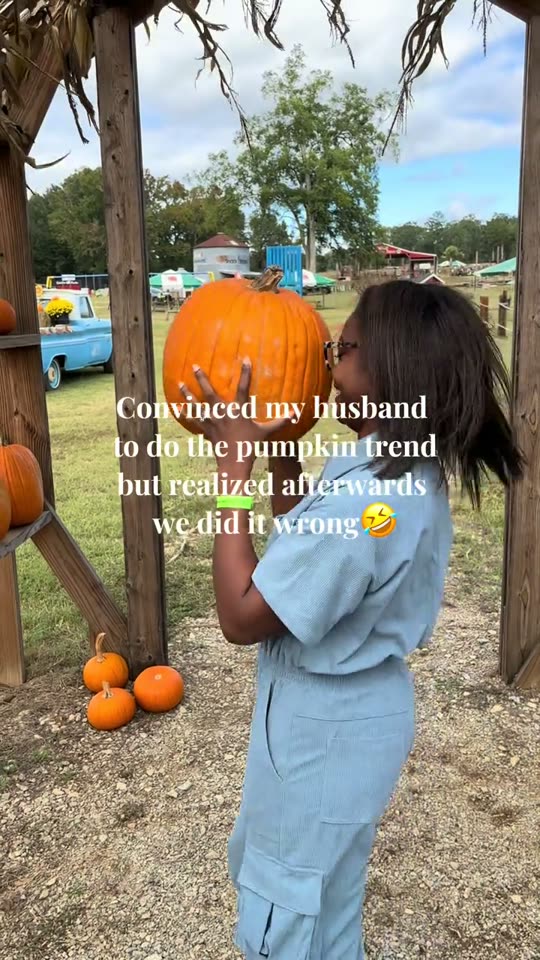 Woman holds pumpkin head