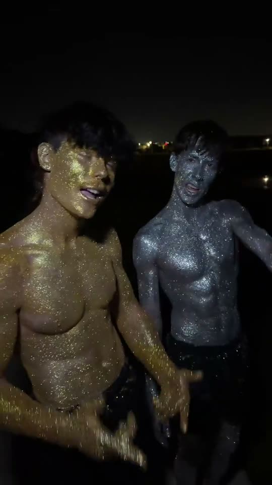 Two men covered in glitter