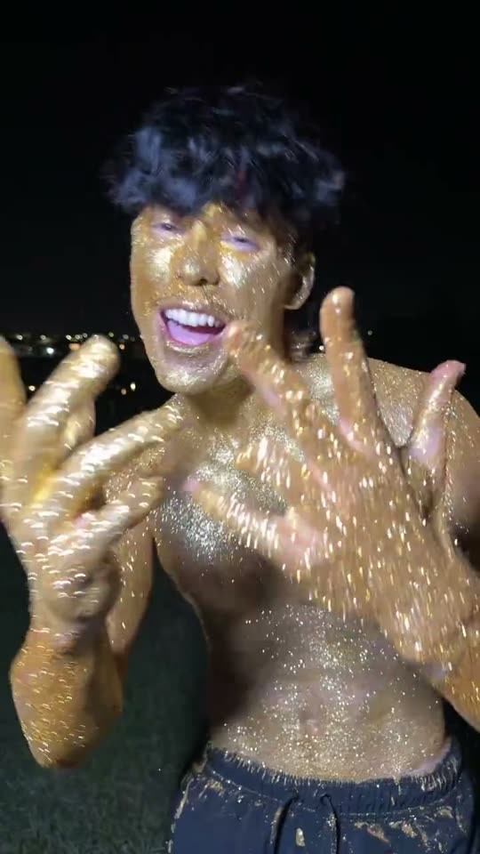 Man covered in gold glitter